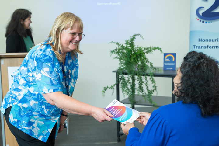 a person receiving Spectrum booklet