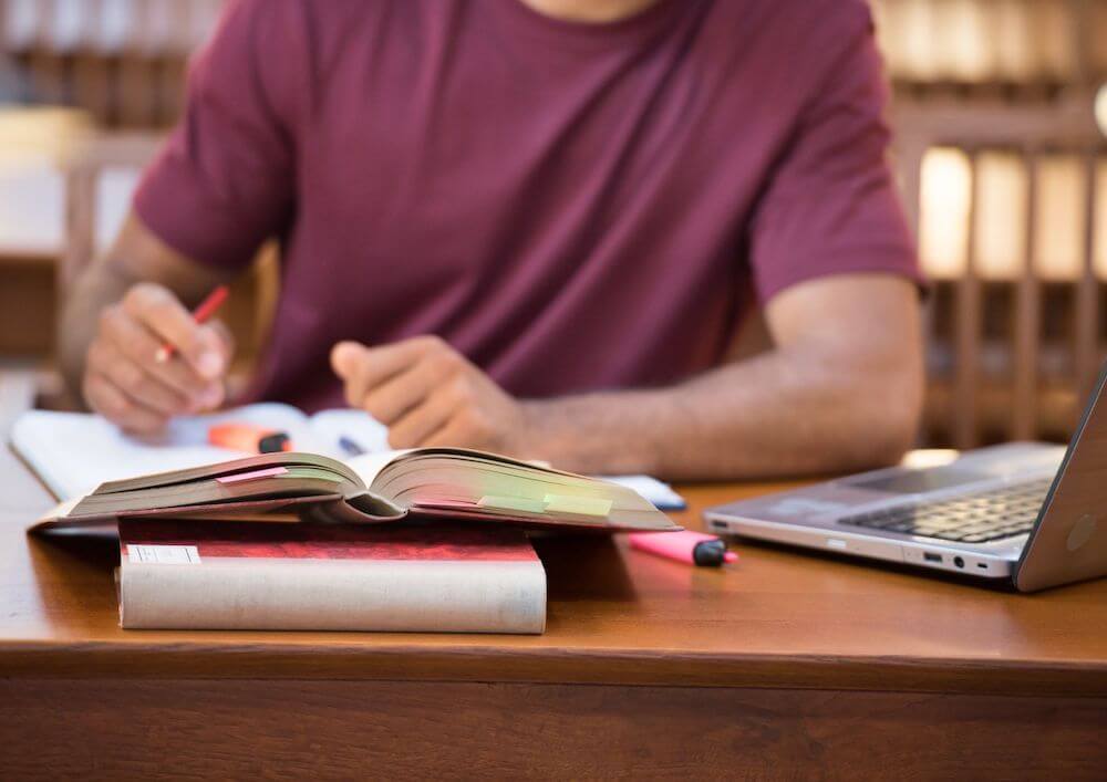 conducting-research-with-open-laptop-and-notes