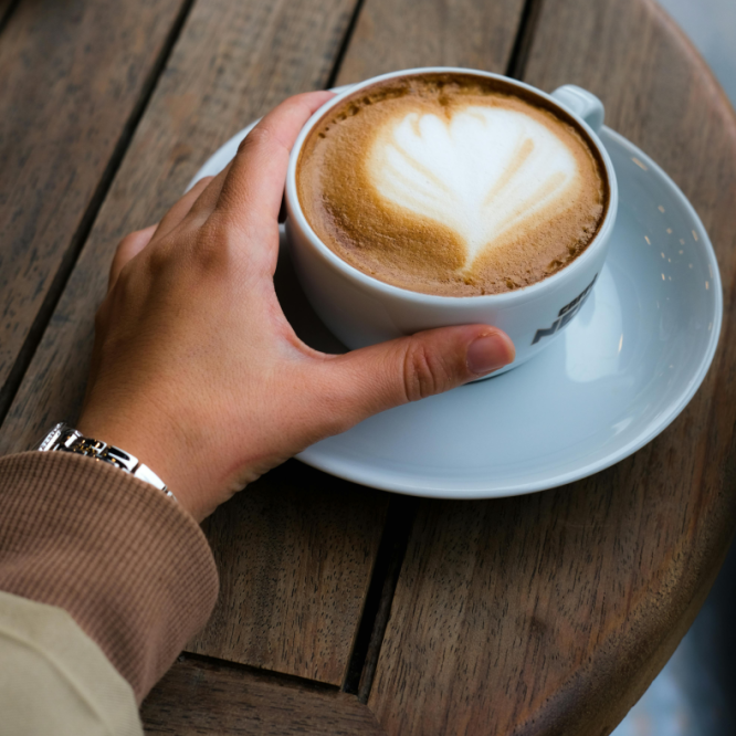 Person holding coffee cup