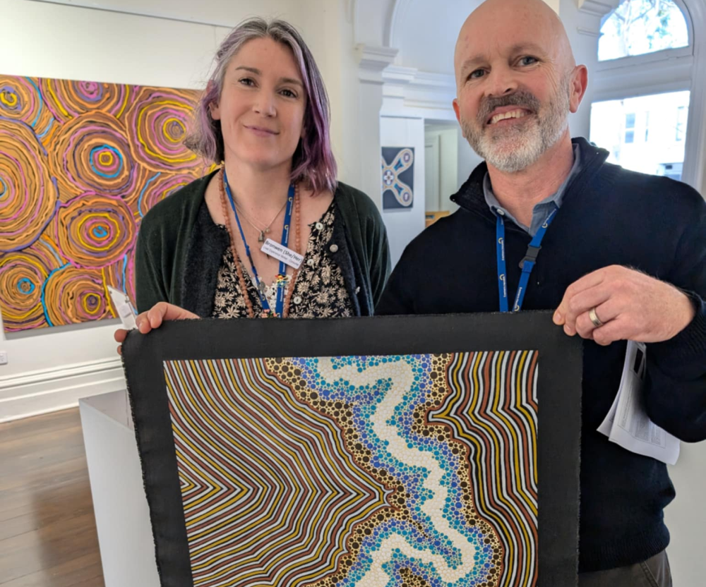Staff holding art from The Torch