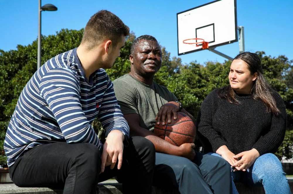 three-individuals-taking-a-break-from-playing-basketball