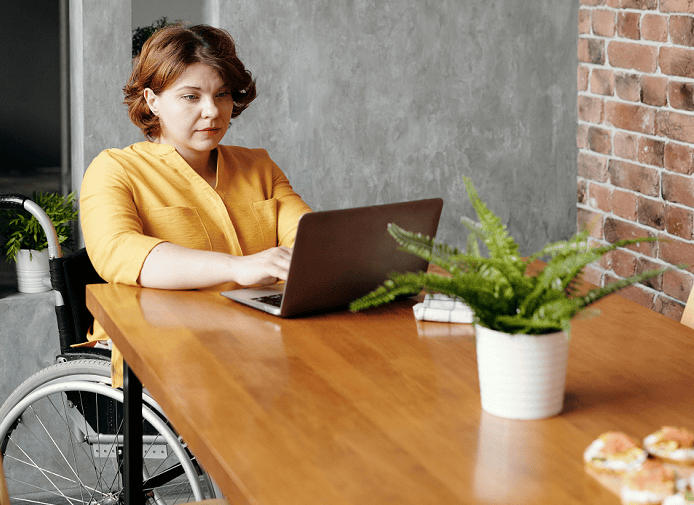 person-in-wheelchair-using-a-laptop person-in-wheelchair-using-a-laptop